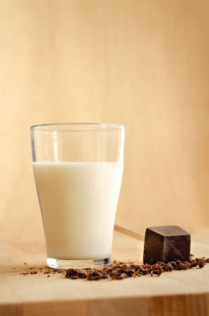 Glass of milk and black chocolateの写真素材