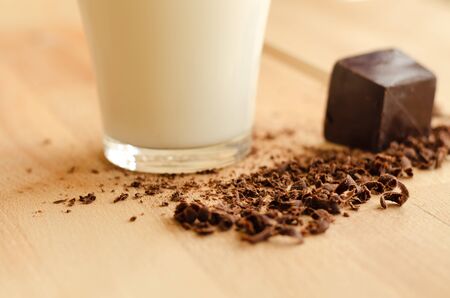 Glass of milk and black chocolateの写真素材