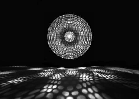 Black and white spotlight. Shiny projector beam. White light show on black background.の写真素材
