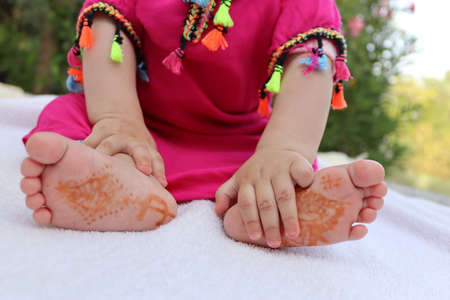Little baby hands and feet. Very cute baby on a white blanket.