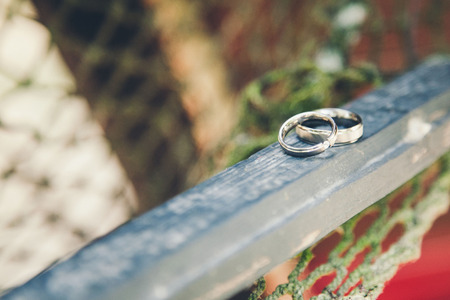 wedding rings on a blue piece of woodのeditorial素材