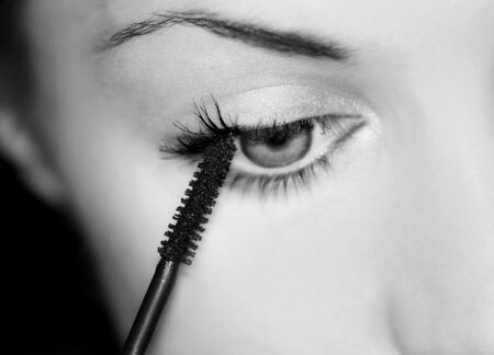 Woman applying make-upの写真素材