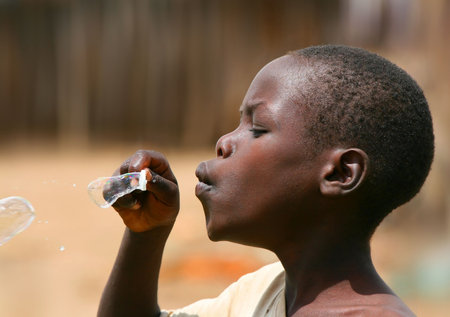Portrait of African kid playing a bubbles.のeditorial素材