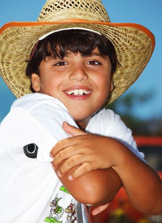 Portrait of a young beautiful boy wearing a hatの写真素材