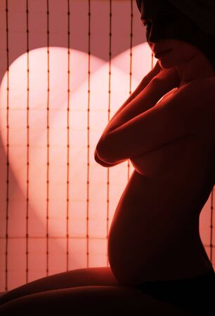 Pregnant woman on red lightの写真素材