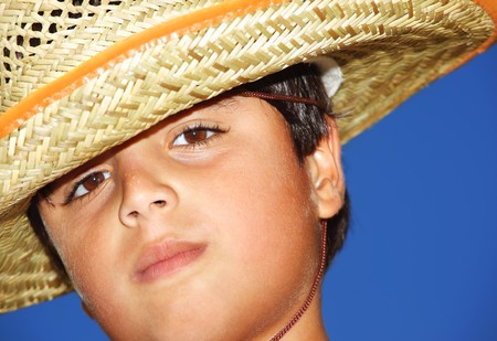 Portrait of a young beautiful boy over blue skyの写真素材