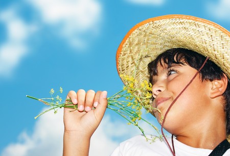 Portrait of a young beautiful boy over blue skyの写真素材
