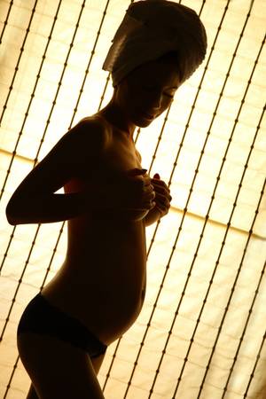 Pregnant woman on soft lightの写真素材
