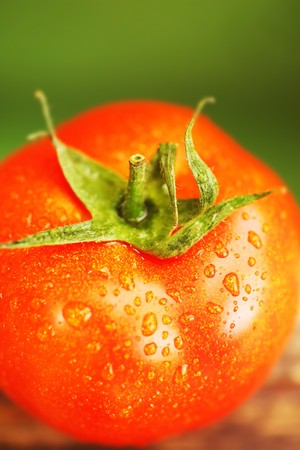 Closeup on red tomato with water drops shallow DOFの写真素材