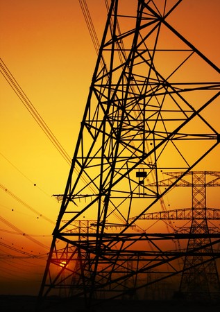 Electricity Pylon over orange sunset sky. Environmental damageの写真素材