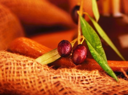 Fresh black olives over burlap canvasの写真素材