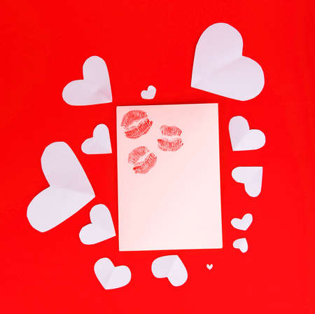 Blank card with red kisses isolated on red background, conceptual image of love & Valentine's day holidayの写真素材