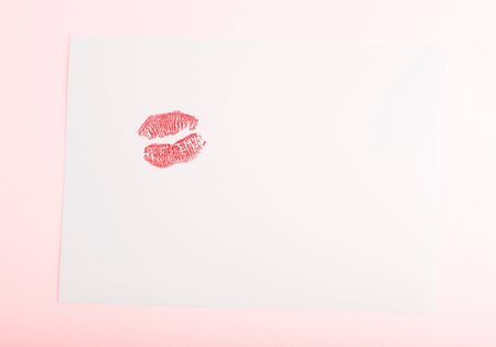 Blank card with red kiss isolated on pink background, conceptual image of love & Valentine's day holidayの写真素材