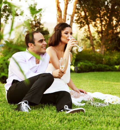 Happy young couple drinking champagne, new family celebrating wedding dayの写真素材