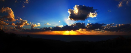 Beautiful sunset on the beach with dramatic sky & clouds, panoramic