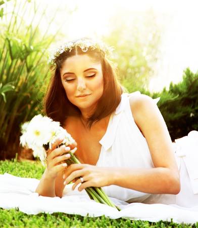 Happy bride lying on the grass, wedding dayの写真素材