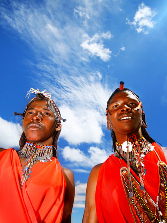 AFRICA, KENYA, MASAI MARA, NOVEMBER 12: portrait on an African  guys of Masai Mara tribe village over blue sky, review of daily life of local people, near to Masai Mara National Park Reserve, November 12, 2008 Kenyaのeditorial素材