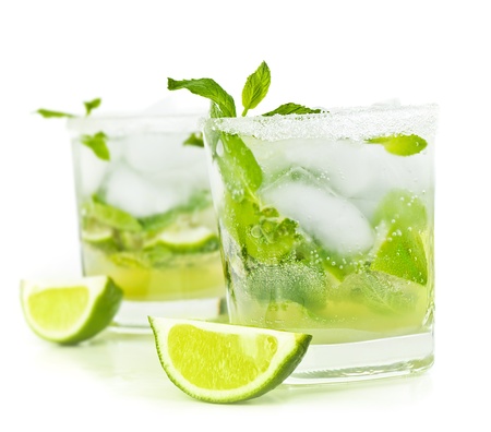 Cold mojito drink, glass of alcohol isolated over white background, fresh mint and lime fruit slice, food still life, party and holidays celebration Cold mojito drink, glass of alcohol isolated over white background, fresh mint and lime fruit slice, food still life, party and holidays celebration