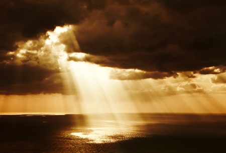 Dramatic sunset on the sea, beautiful peaceful scene, bright sun light, rays of light shine in...
