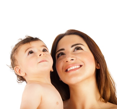 Happy mother holding baby boy, cute smiling faces looking up, playing family picture, brunette mom and child isolated on white  background, pretty Arabic mommy with son, kids care, happiness conceptの写真素材