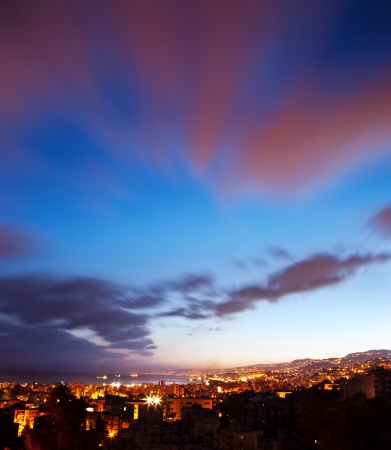 Night city landscape, big town cityscape, pink summer sunset, beautiful sky nature background, Beirut skyline at night time, scenic Mediterranean sea shore, street lights and skyscrapers, Lebanonの写真素材