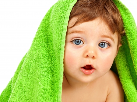 Image of cute baby boy covered green towel isolated on white backgroundの写真素材