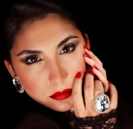 Photo of luxury female wearing stylish jewelery, closeup portrait of beautiful woman with seductive makeup isolated on black background, sexy girl, red lips, Valentine day, beauty and elegance conceptの写真素材