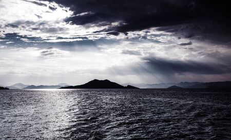 Beautiful night seascape, abstract natural background, dramatic cloudscape, island in moonlight,...