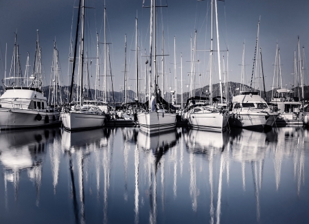 Sailboat harbor in evening, many luxury moored sail yacht in the port, ship mast reflected in water, marina in European city, summer holidaysの写真素材