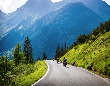 Moto racers riding on mountainous road, drive a motorcycle, summer adventure, extreme sport, travel to Europe, active lifestyle, vacation conceptの写真素材