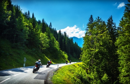 Bikers in mountainous tour, travelling across Europe, curve highway in mountains, scene destinations, extreme transport, active lifestyleの写真素材