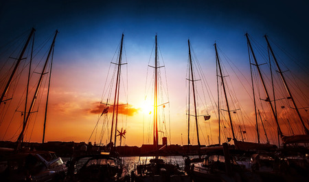 Sailboats mast on beautiful sunset background, harbour for sail yacht in the night, old marina in European city, travel and tourism conceptの写真素材