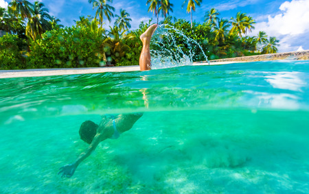 Woman swimming underwater, diving in turquoise transparent sea, wonderful tropical nature, summer...