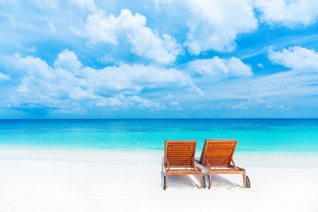 Two empty sunbed on the beach, beautiful seascape, relaxation on Maldives island, luxury summer vacation conceptの写真素材