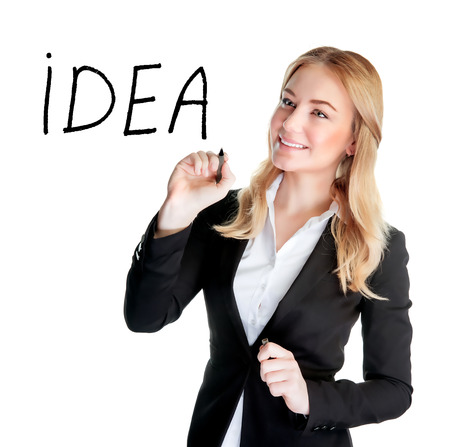 Portrait of an attractive business woman writing word Idea, isolated on white background, modern society, smart office people conceptの写真素材