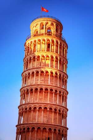 Leaning tower of Pisa on blue sky background, Europe, Italy, ancient medieval architecture, famous European landmark, travel and tourism conceptの写真素材