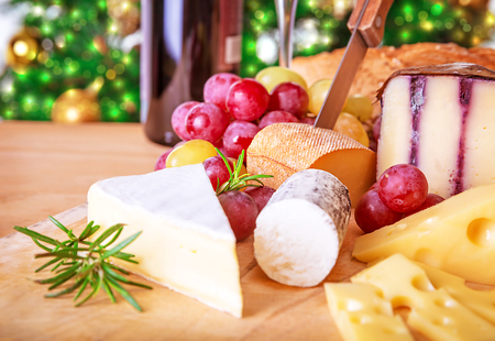 Christmas eve table, festive food still life, romantic cheese and wine set up, celebrating Xmas party at homeの写真素材