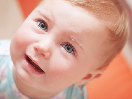 Closeup portrait of cute sad baby, upset little child with tears on eyes, innocent small girl weeping, unhappy childhood or hungry kid conceptの写真素材