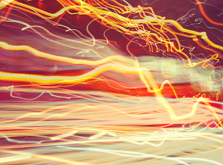 Abstract glowing background, blurry car lights, long exposure, traffic on the road, slow motion, creative wallpaperの写真素材