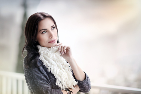 Portrait of a beautiful peaceful woman relaxing outdoors, spending spring day on the terrace in the countryside, enjoying time outdoorsの写真素材