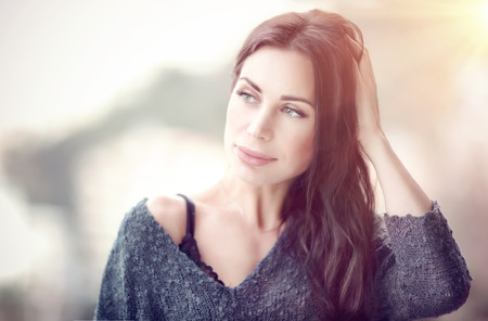 Portrait of a beautiful gentle woman in the morning, calm sensual female outdoors, having a good beginning of a nice dayの写真素材