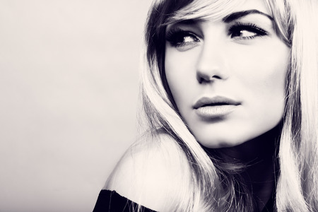 Closeup portrait of a gorgeous blond model, fashion look, beautiful makeup and hairstyle, black and white photo with copy space の写真素材