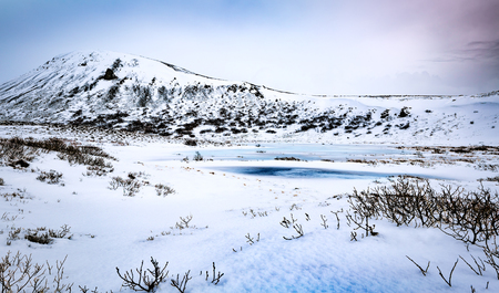 Beautiful winter landscape, amazing panoramic view on the little frozen lake and majestic mountains behind it, extreme travel to Iceland
の写真素材