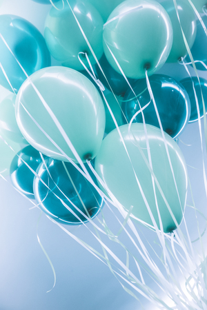 Blue air balloons background, big bunch of a helium balloons, happy birthday celebration, surprise for holiday, party decorationの写真素材
