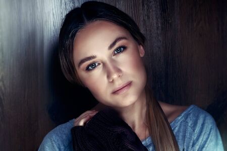 Portrait of a beautiful young woman with natural makeup over wooden background, calm and peaceful female, genuine women's beauty concept
の写真素材