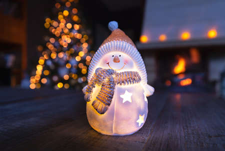 Stylish Christmas decoration, nice little ceramic snowman souvenir, New Year holidays in the cozy...