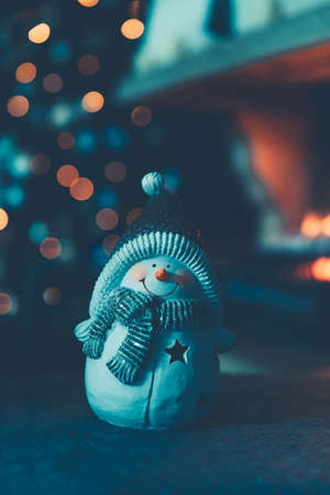 Vintage style photo of a Christmas decoration, nice little ceramic snowman souvenir, New Year...