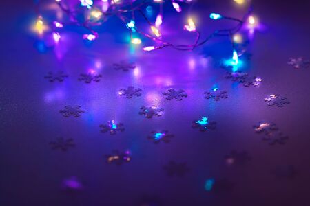 New Year background, festive decoration, colorful garland and little snowflakes confetti, beautiful...