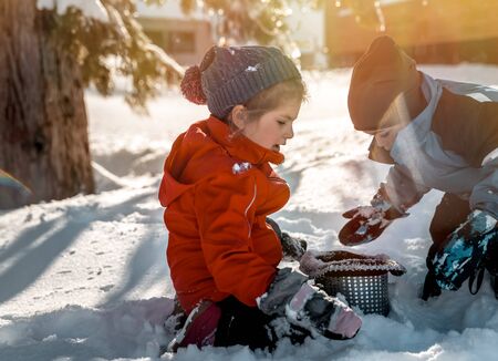Happy children playing outdoors,  enjoying traditional winter funの写真素材