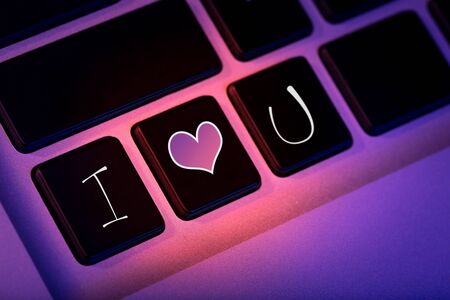 Love message on the keyboard key of a laptop, mystery declaration of love, creative romantic idea,...